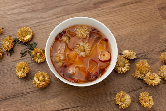 Chrysanthemum tea jelly in a white ramekin topped with wolfberries, chrysanthemum petals, and sliced red dates made with Yeo's Chrysanthemum Tea