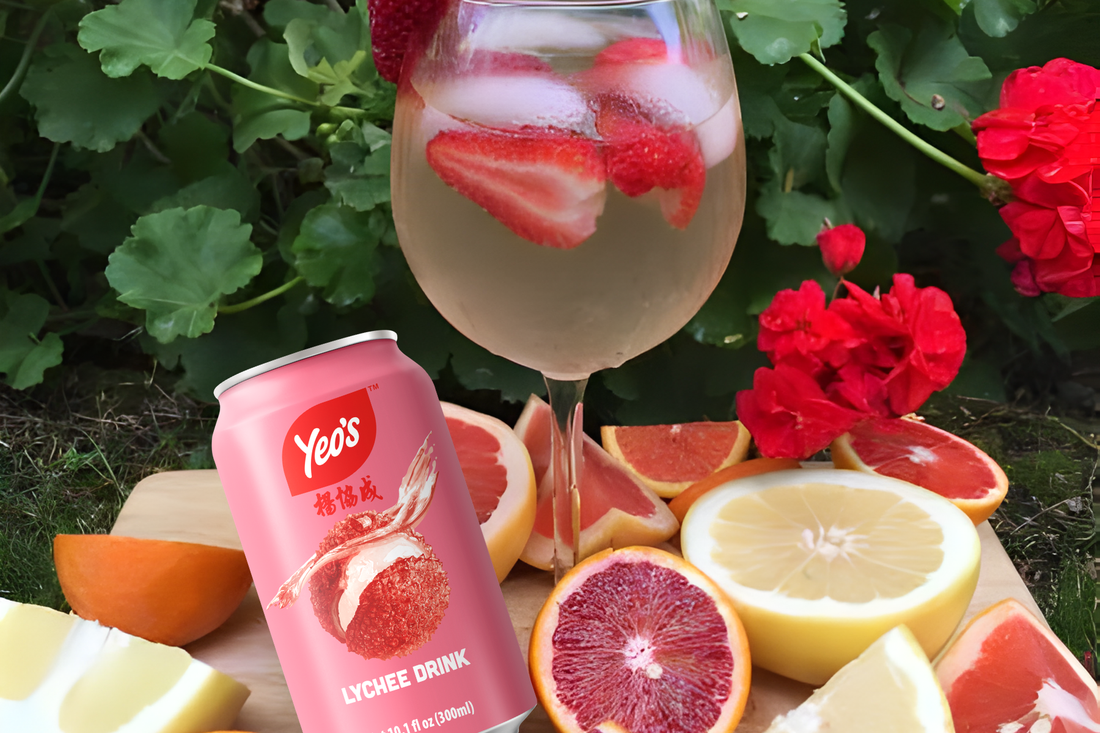 Grapefruit lychee cooler in a glass with fresh mint, grapefruit slices, and ice made with Yeo's Lychee Drink