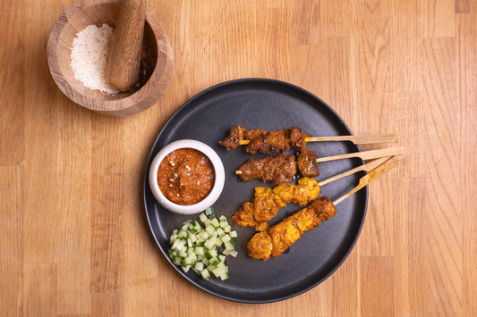 Grilled satay meat skewers served with Yeo's Satay Sauce for dipping and fresh cucumber slices